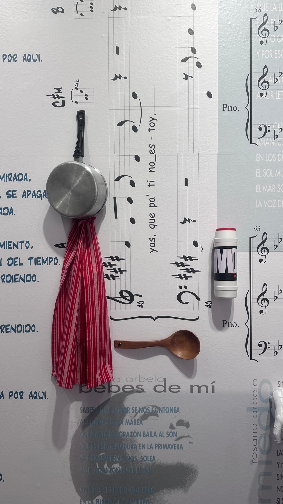 Sartén, bote y cuchara sobre la pared de partituras